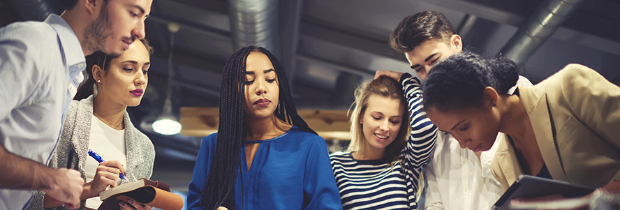 A group of people looking down at a table